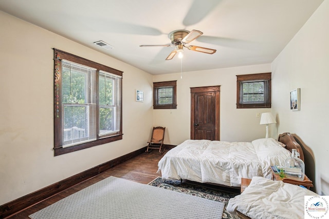 309 E Gay St, Warrensburg, MO 64093 - bedroom featuring multiple windows, wood finished floors, and a ceiling fan