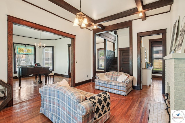 309 E Gay St, Warrensburg, MO 64093 - living room with a chandelier, beamed ceiling, a desk, stairway, and wood finished floors