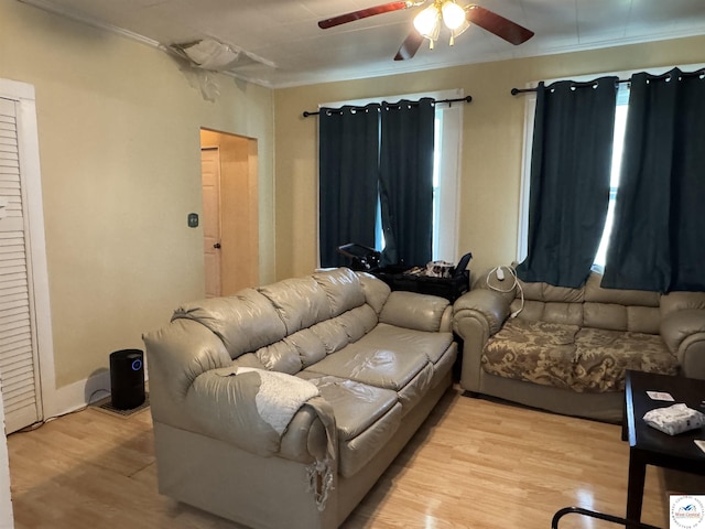 405 W 4th St, Sedalia, MO 65301 - living room featuring a ceiling fan, light wood finished floors, and ornamental molding