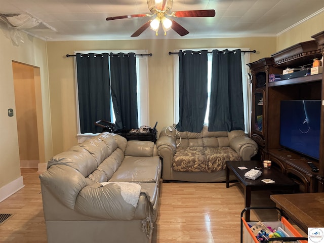 405 W 4th St, Sedalia, MO 65301 - living room with visible vents, ornamental molding, baseboards, a ceiling fan, and light wood-style flooring