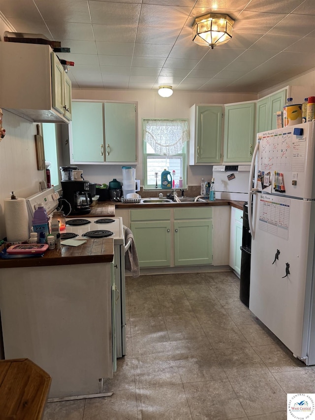 405 W 4th St, Sedalia, MO 65301 - kitchen with green cabinets, a sink, dark countertops, and white appliances