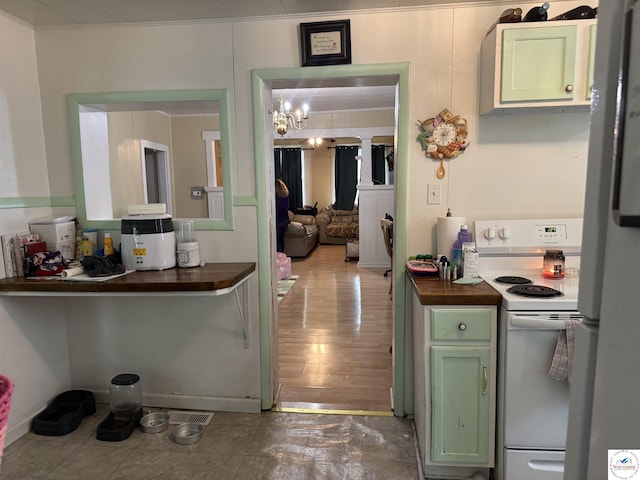 405 W 4th St, Sedalia, MO 65301 - kitchen featuring green cabinets, white appliances, and a notable chandelier