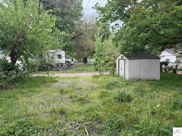 405 W 4th St, Sedalia, MO 65301 - view of yard with a storage shed, fence, and an outbuilding