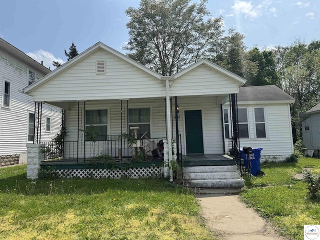 405 W 4th St, Sedalia, MO 65301 - view of front of house featuring a porch and a front lawn