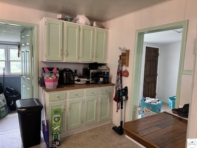 405 W 4th St, Sedalia, MO 65301 - kitchen featuring stainless steel microwave and green cabinets