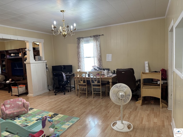 405 W 4th St, Sedalia, MO 65301 - interior space featuring crown molding, an inviting chandelier, decorative columns, and wood finished floors