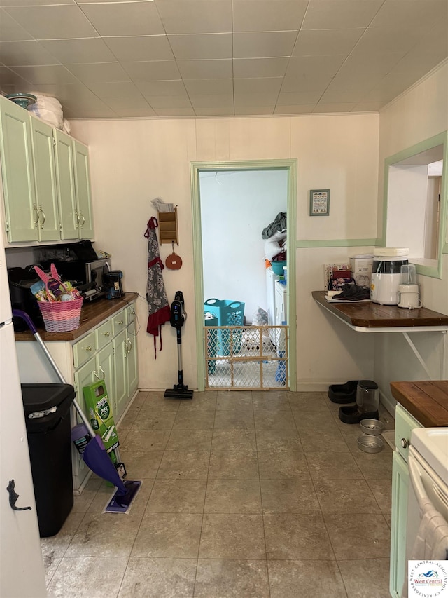 405 W 4th St, Sedalia, MO 65301 - interior space with green cabinetry and light tile patterned floors