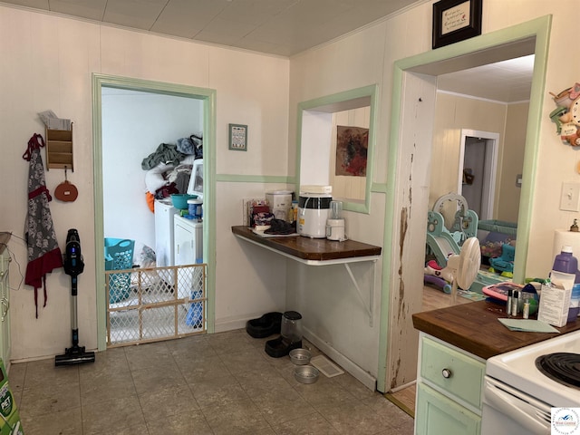 405 W 4th St, Sedalia, MO 65301 - hallway with washer / dryer and tile patterned floors