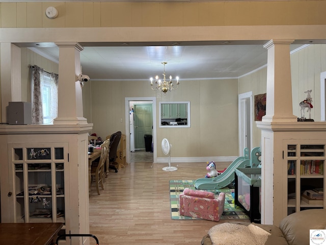 405 W 4th St, Sedalia, MO 65301 - living room featuring ornamental molding, ornate columns, wood finished floors, and a chandelier