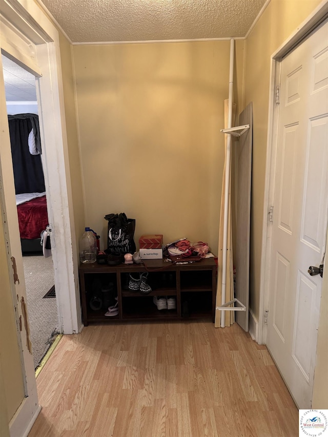 405 W 4th St, Sedalia, MO 65301 - mudroom featuring crown molding, a textured ceiling, and wood finished floors