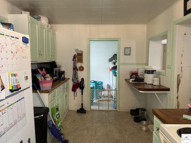 405 W 4th St, Sedalia, MO 65301 - kitchen featuring green cabinetry, dark countertops, tile patterned floors, and white electric stove