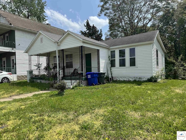 405 W 4th St, Sedalia, MO 65301 - view of front of property featuring a porch, a chimney, and a front yard