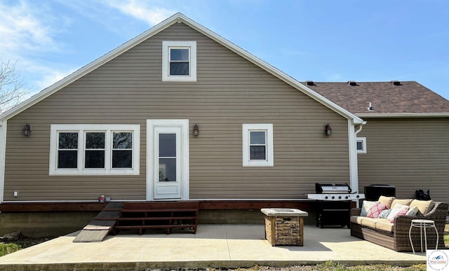 back of property with an outdoor hangout area, entry steps, and a patio area