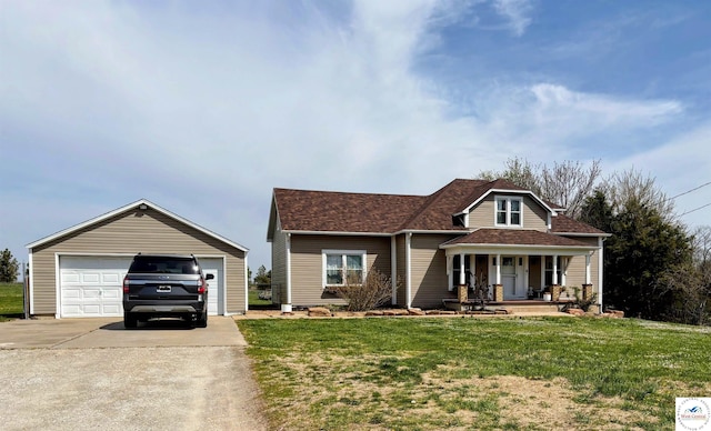 view of front of property with an outdoor structure, covered porch, a detached garage, and a front lawn