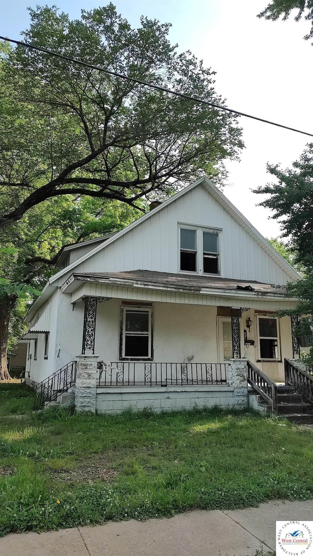 bungalow-style house with board and batten siding and a porch
