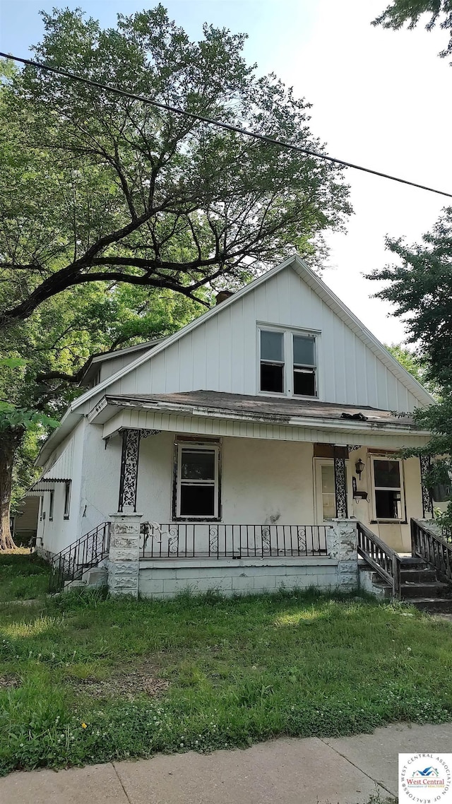 bungalow-style house with board and batten siding and a porch