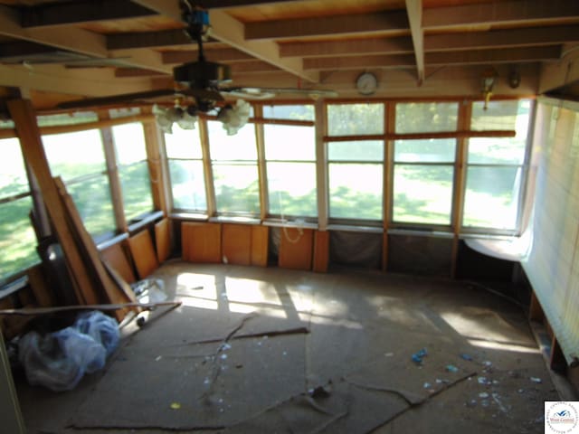 unfurnished sunroom featuring ceiling fan