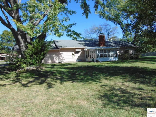 view of yard featuring a sunroom