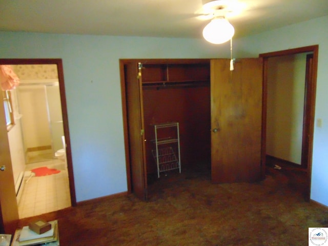 unfurnished bedroom featuring baseboards and ensuite bathroom