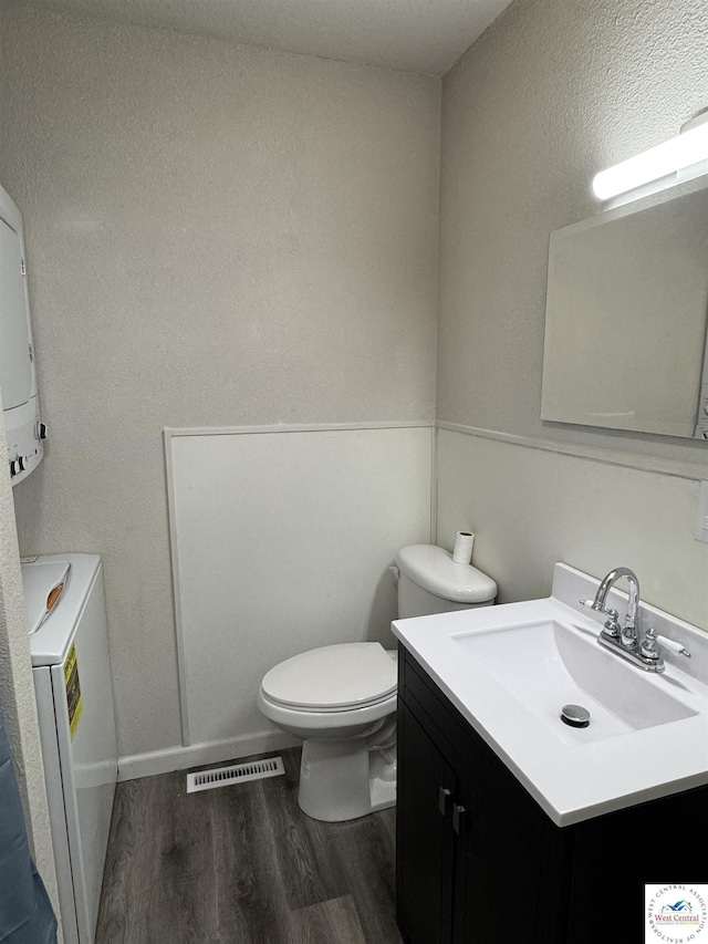 1404 S Grand Ave, Sedalia, MO 65301 - half bathroom with visible vents, wood finished floors, toilet, and vanity