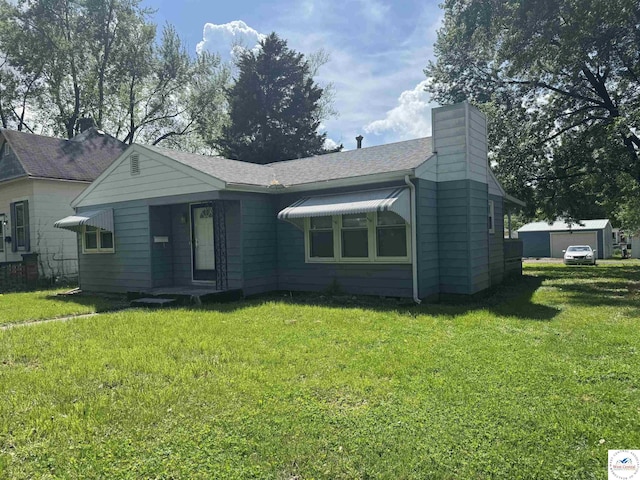 1404 S Grand Ave, Sedalia, MO 65301 - view of front of house with a front lawn, roof with shingles, and a chimney