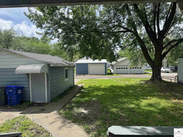 1404 S Grand Ave, Sedalia, MO 65301 - view of yard with a detached garage and an outdoor structure