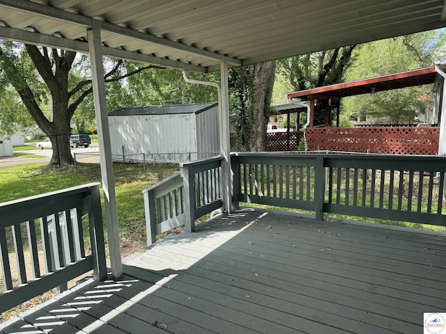 1404 S Grand Ave, Sedalia, MO 65301 - deck featuring a storage unit and an outbuilding