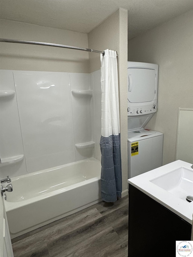 1404 S Grand Ave, Sedalia, MO 65301 - bathroom featuring vanity, stacked washer / dryer, shower / bath combo, and wood finished floors