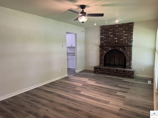 1404 S Grand Ave, Sedalia, MO 65301 - unfurnished living room with track lighting, baseboards, and a ceiling fan
