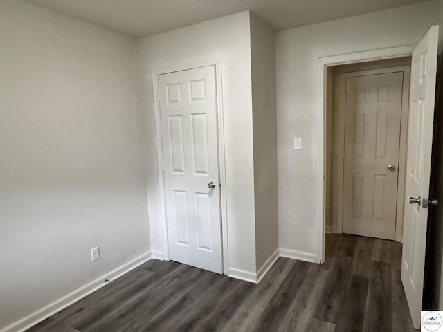 1404 S Grand Ave, Sedalia, MO 65301 - corridor featuring baseboards and dark wood-type flooring