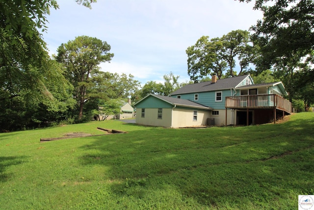 view of yard with central AC unit and a wooden deck