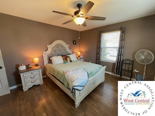 412 E Walnut St, Clinton, MO 64735 - bedroom with wood finished floors, baseboards, and a ceiling fan