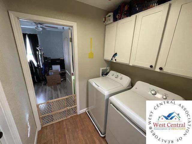 412 E Walnut St, Clinton, MO 64735 - laundry area with washer and dryer, dark wood-type flooring, cabinet space, baseboards, and ceiling fan
