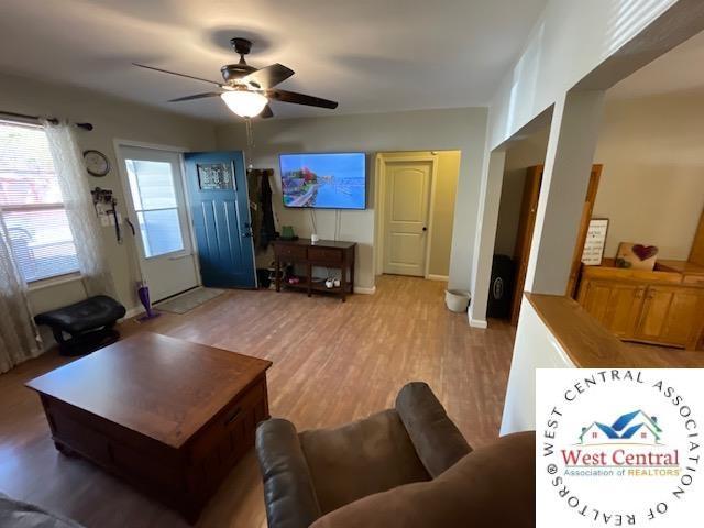 412 E Walnut St, Clinton, MO 64735 - living room with a ceiling fan, wood finished floors, and baseboards