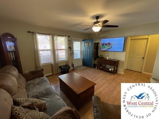 412 E Walnut St, Clinton, MO 64735 - living area with a ceiling fan, wood finished floors, and baseboards