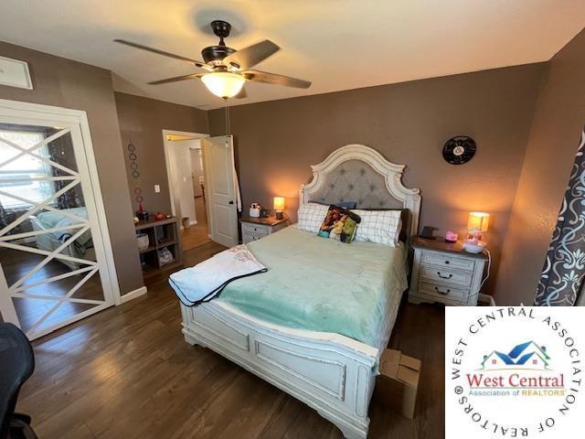 412 E Walnut St, Clinton, MO 64735 - bedroom featuring dark wood-style flooring, ceiling fan, and baseboards