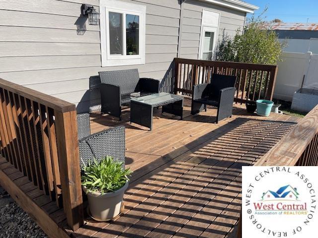 412 E Walnut St, Clinton, MO 64735 - wooden deck featuring an outdoor living space