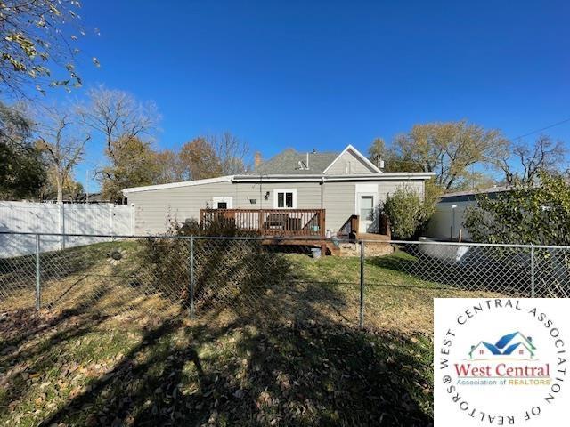 412 E Walnut St, Clinton, MO 64735 - back of house featuring a fenced backyard and a wooden deck