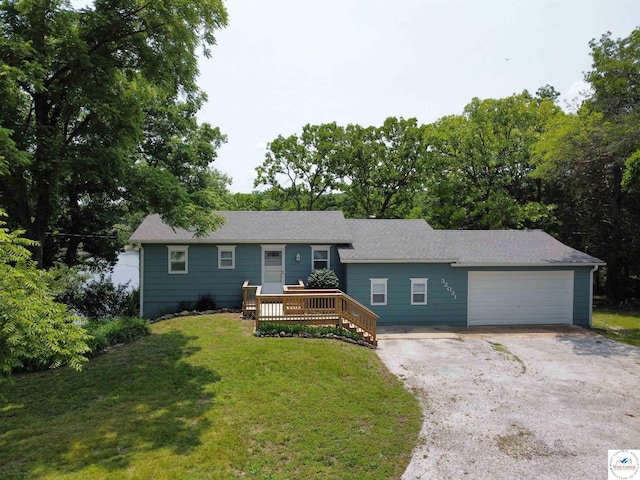 32031 Barclay Loop, Warsaw, MO 65355 - single story home featuring driveway, a garage, a wooden deck, a front yard, and a shingled roof
