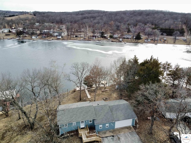 bird's eye view with a wooded view