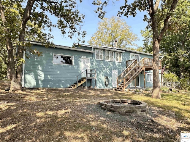 back of property featuring a fire pit, a deck, and stairway