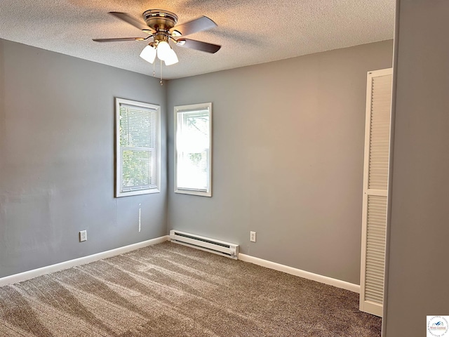 carpeted spare room with a textured ceiling, ceiling fan, baseboard heating, and baseboards