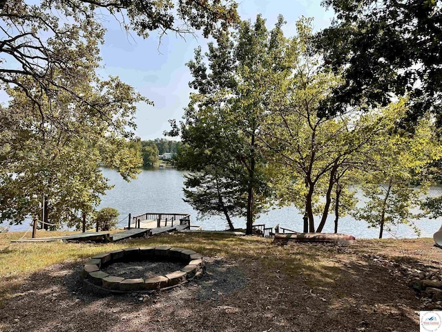 property view of water with an outdoor fire pit