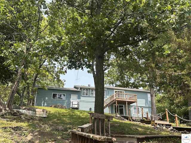32031 Barclay Loop, Warsaw, MO 65355 - rear view of house featuring a wooden deck, stairway, and a yard