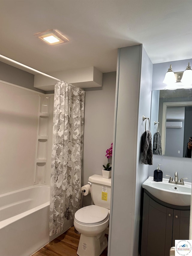 full bathroom with shower / bathtub combination with curtain, vanity, a wall mounted air conditioner, toilet, and wood finished floors
