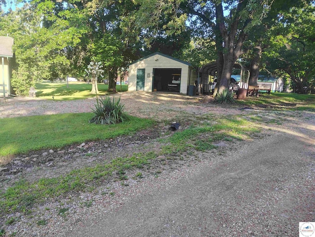 29620 Blue Grass Rd, Edwards, MO 65326 - view of green lawn featuring an outdoor structure, a detached garage, and a carport