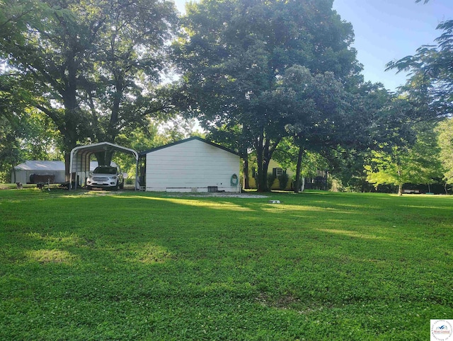 29620 Blue Grass Rd, Edwards, MO 65326 - view of green lawn with a detached carport