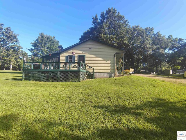 29620 Blue Grass Rd, Edwards, MO 65326 - view of side of home featuring a wooden deck and a yard