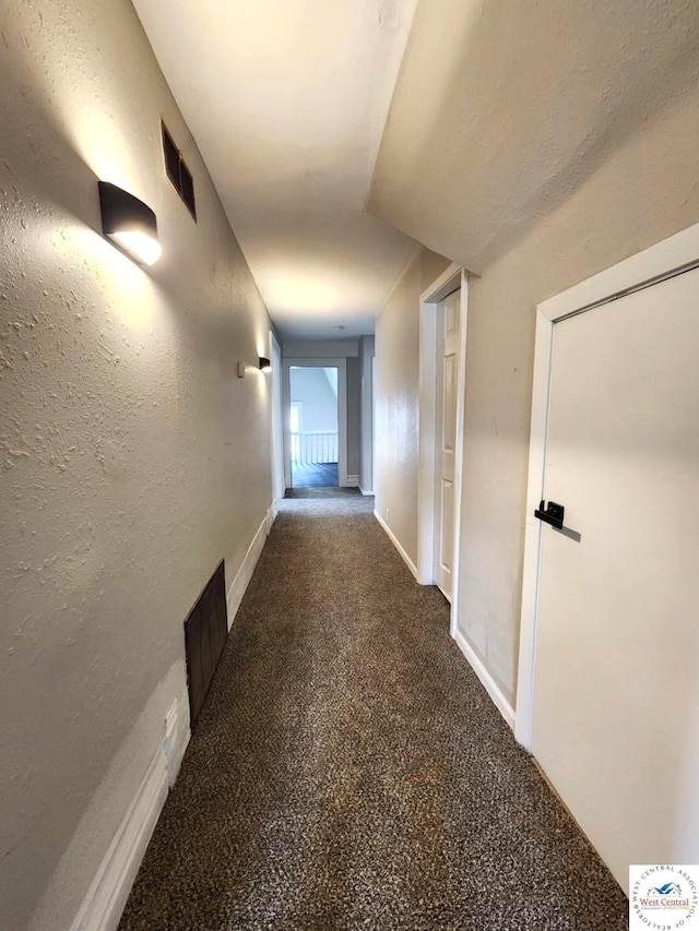 hall with visible vents and carpet