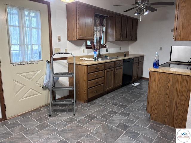 946 Red Bud Dr, Warsaw, MO 65355 - kitchen featuring black dishwasher, a sink, ceiling fan, light countertops, and baseboards